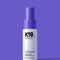 A spray bottle of Mini AirWash dry shampoo against a purple background.