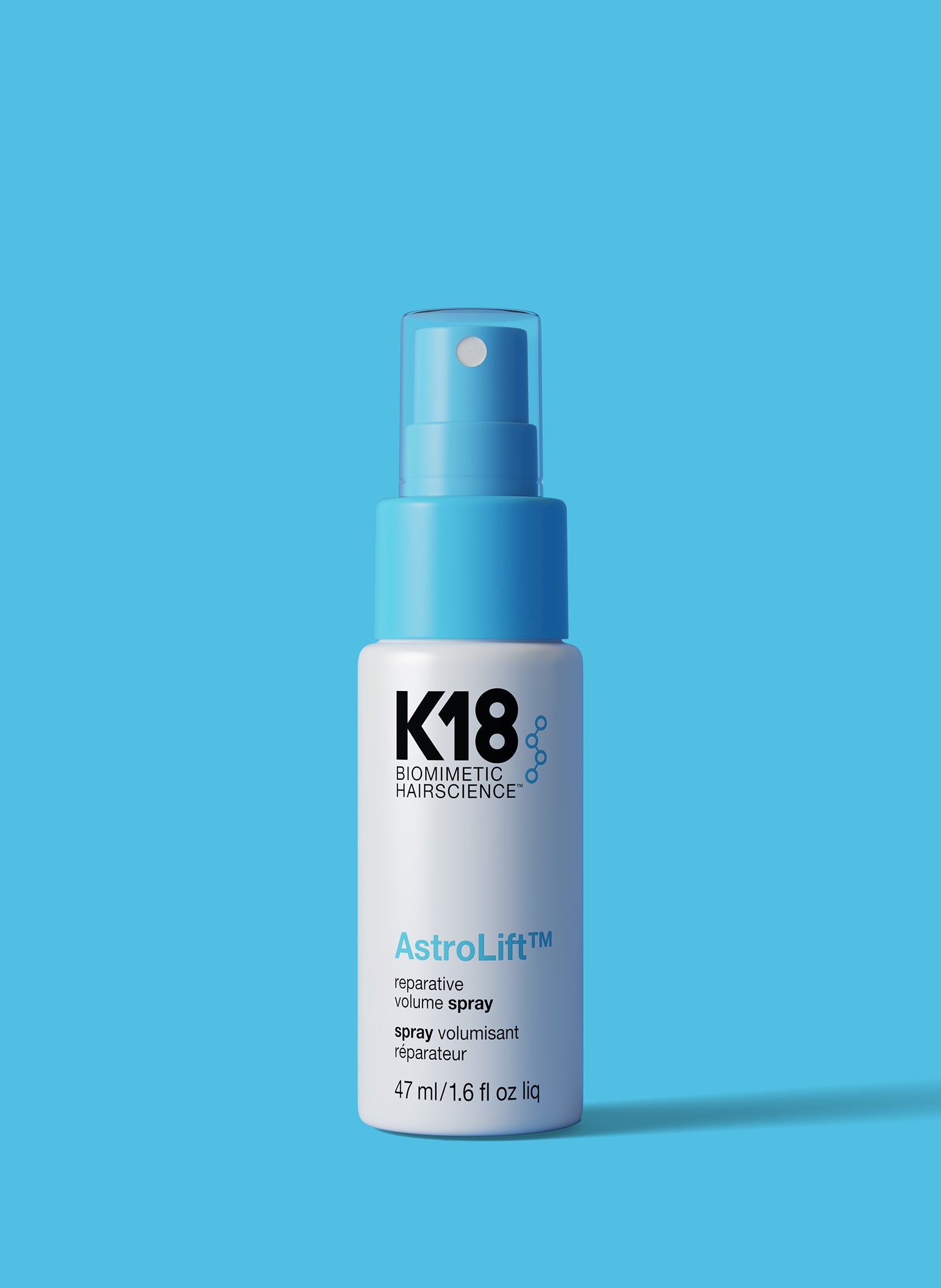 K18 AstroLift hair spray bottle on a blue background