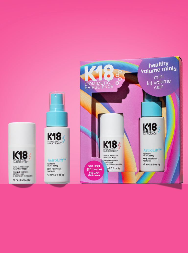 k18-hair-care-products-including-bottles-and-a-box-on-a-pink-background