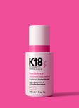 K18 HeatBounce conditioning heat protectant bottle on a pink background