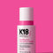 K18 HeatBounce conditioning heat protectant bottle on a pink background