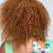 Red curly hair before and after results using k18. 