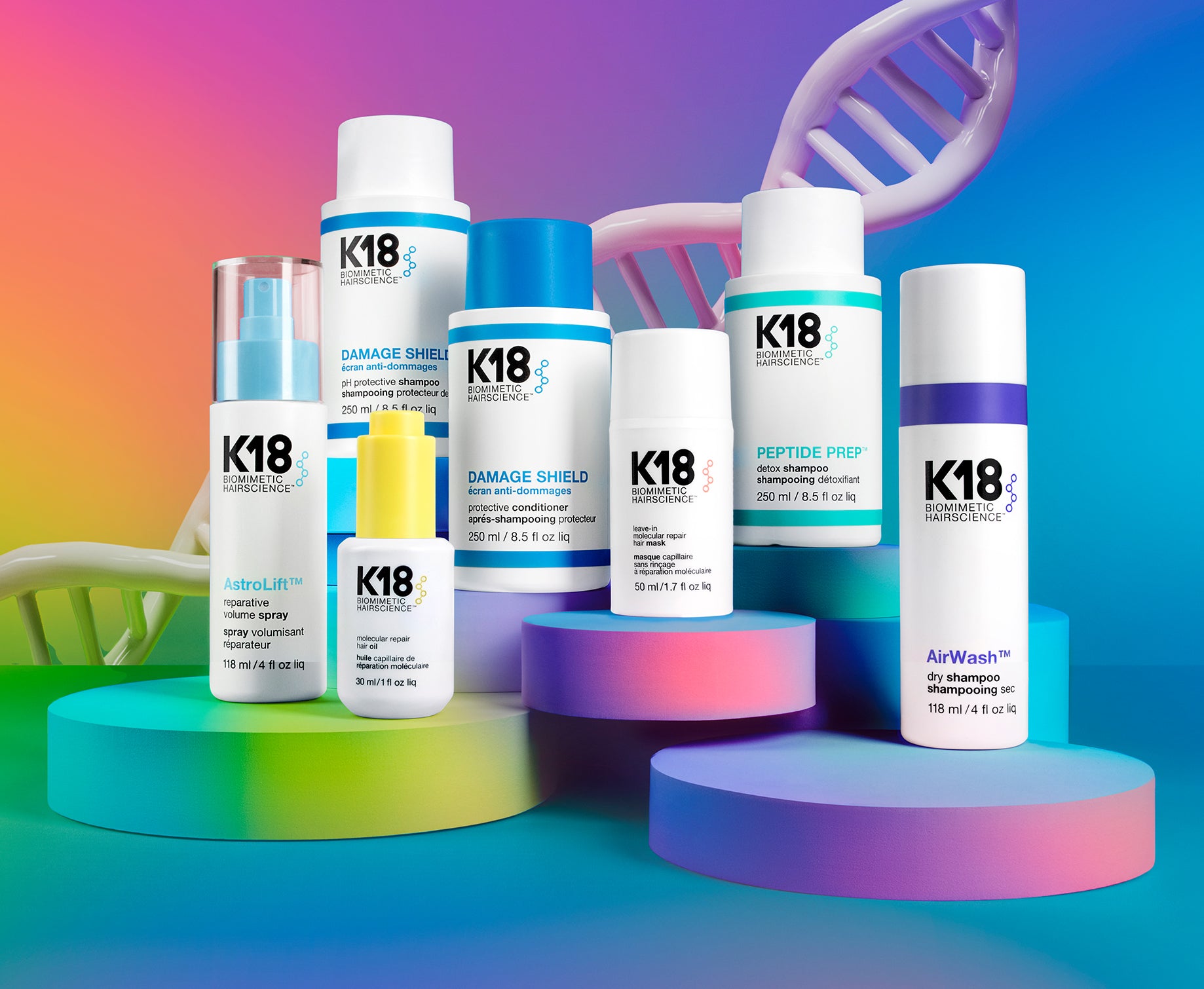 K18 hair care products on colorful platforms with a blue gradient background